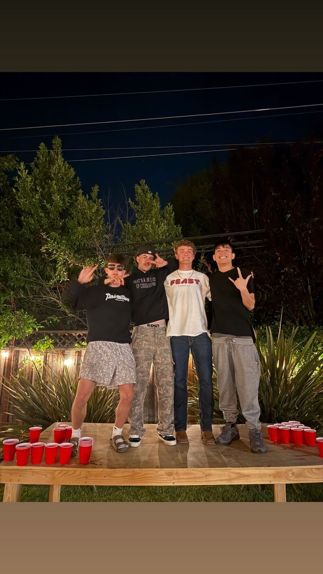 Jake with friends at a party in a casual indoor setting.